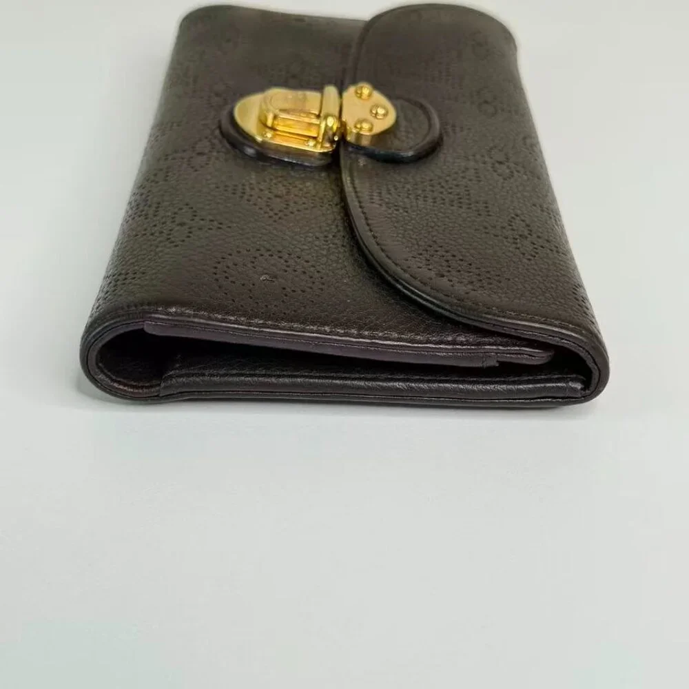 Louis Vuitton Black Monogram Canvas Wallet with Gold Hinge Detail Elegant Design